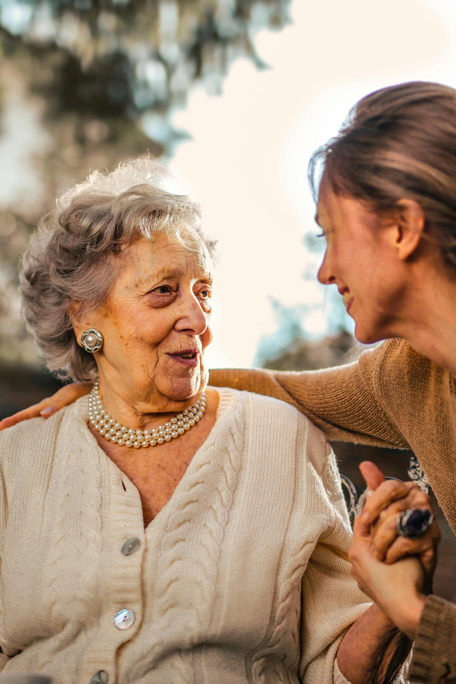 A photo of a grandmother and granddaughter holding hands